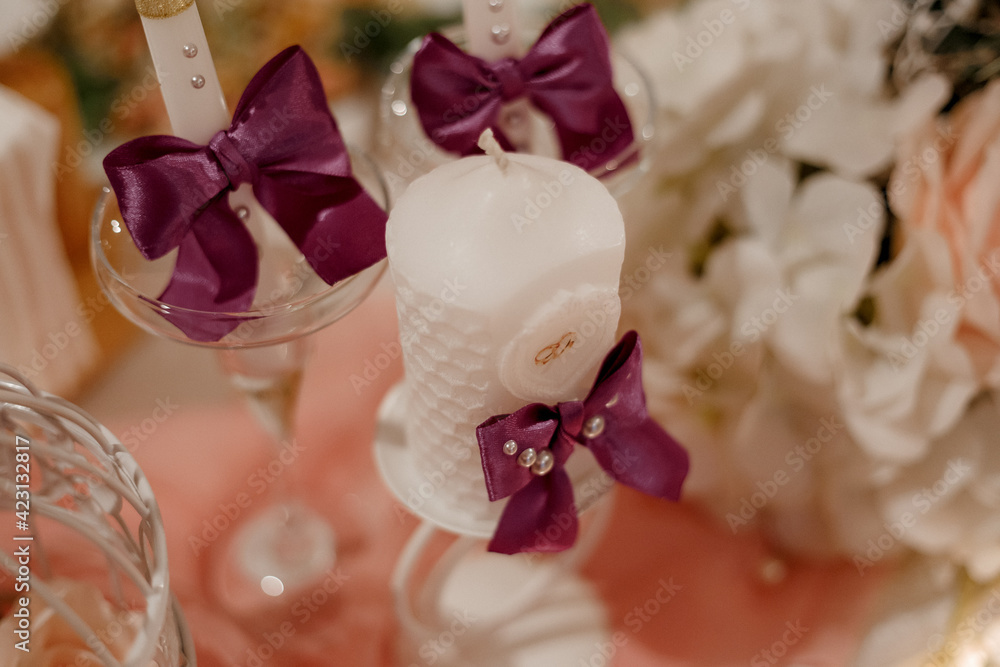 white candles decorated with ribbons white candles decorated with ribbons