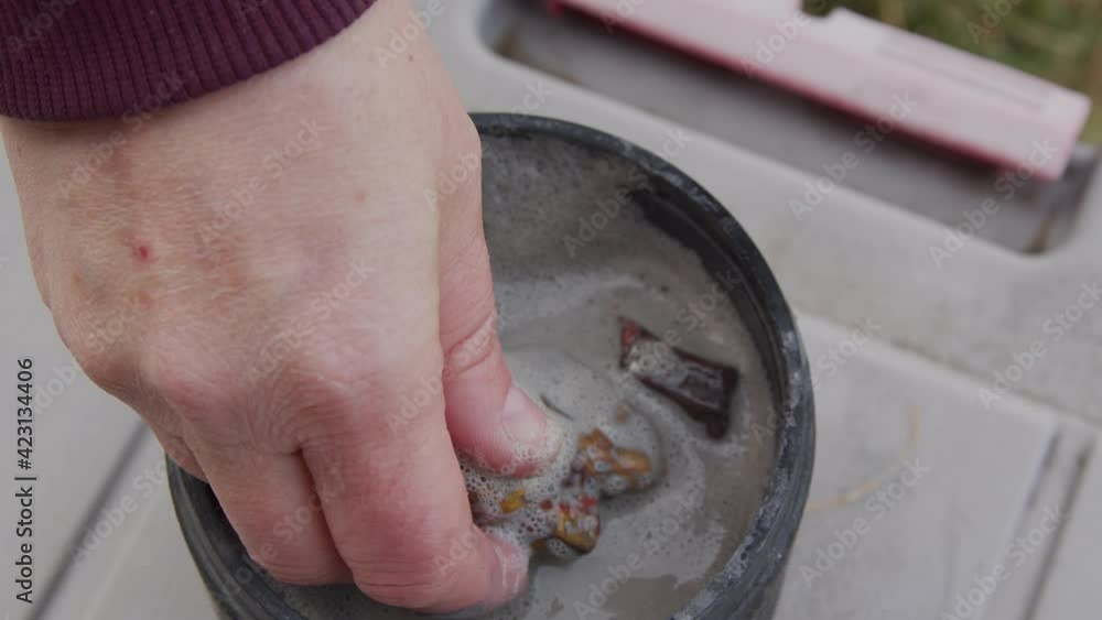 Rock being pulled from barrel in grit to inspect during tumbling process to see what the next step should be for doing lapidary. Rock being pulled from barrel in grit to inspect during tumbling process to see what the next step should be for doing lapidary.
