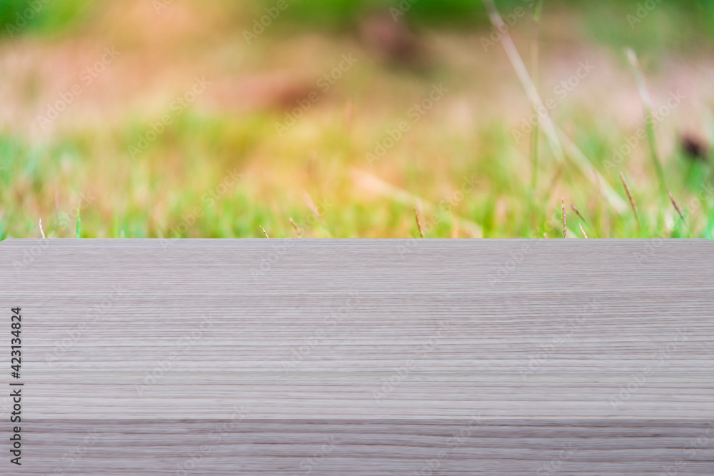 Fototapeta premium Empty wood table shelf and blurred grass nature background. Product display template. Business presentation concept.
