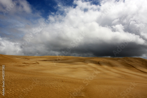 Dark cloud in the sandy dunes, natural landscape background