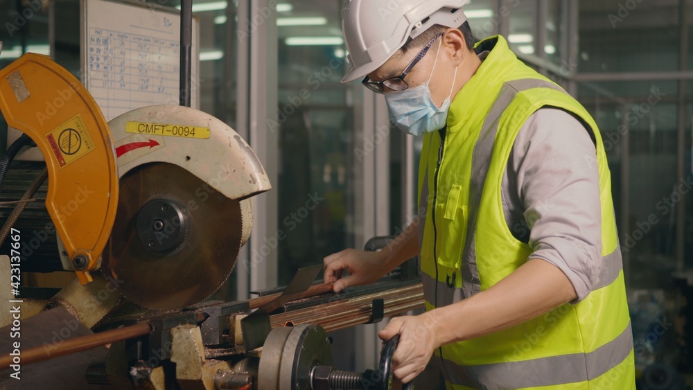 worker wear uniforms, safety helmets use a tape measure to measure the steel pipe before cutting worker wear uniforms, safety helmets use a tape measure to measure the steel pipe before cutting