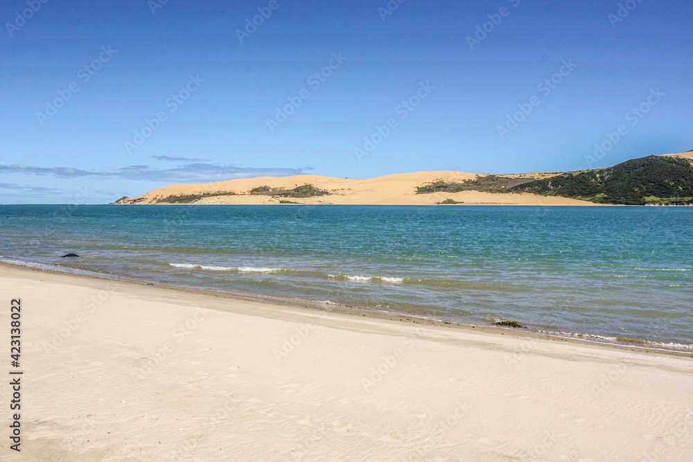 White sandy beach and azure sea, blue sky background, no people