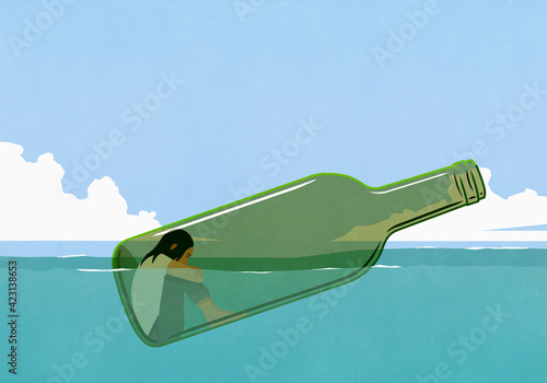 Depressed woman inside glass bottle floating in sea
 photo