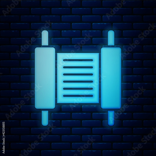 Glowing neon Torah scroll icon isolated on brick wall background. Jewish Torah in expanded form. Star of David symbol. Old parchment scroll. Vector