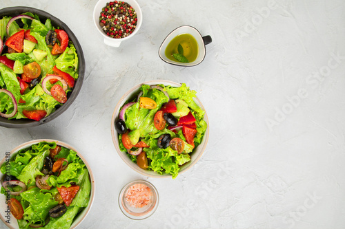 Fresh vegetables salad on light gray background. Healthy eating concept.