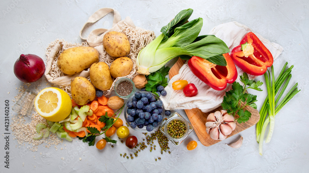 Selection of fresh raw vegetables, fruits and beans on light gray background. Selection of fresh raw vegetables, fruits and beans on light gray background.
