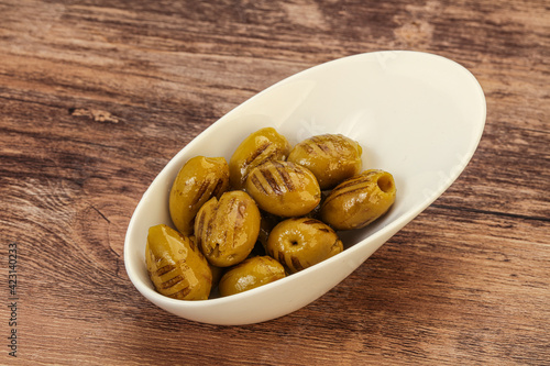Green grilled olives in the bowl