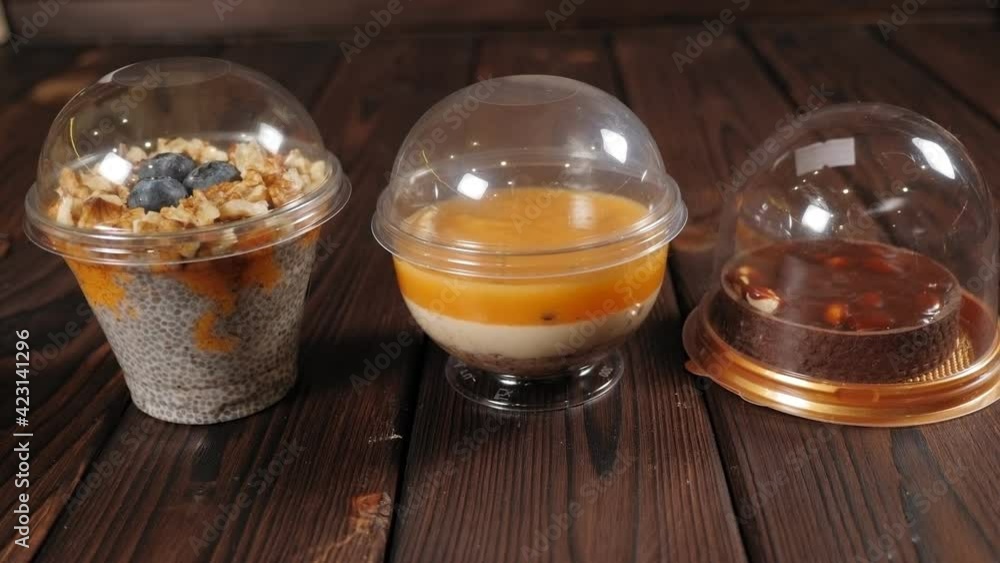 Close-up of various fruit desserts with chia seeds, nuts and berries on a table. Close-up of various fruit desserts with chia seeds, nuts and berries on a table.