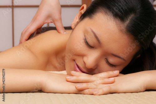 Close up serene young woman receiving massage in spa
 photo