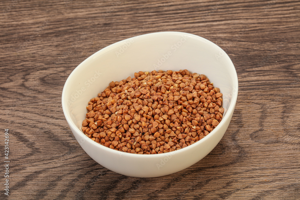 Raw buсkwheat cereal in the bowl Raw buсkwheat cereal in the bowl