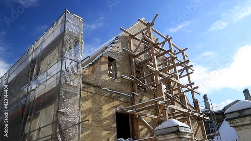 Old brick building renovation wooden scaffolding 