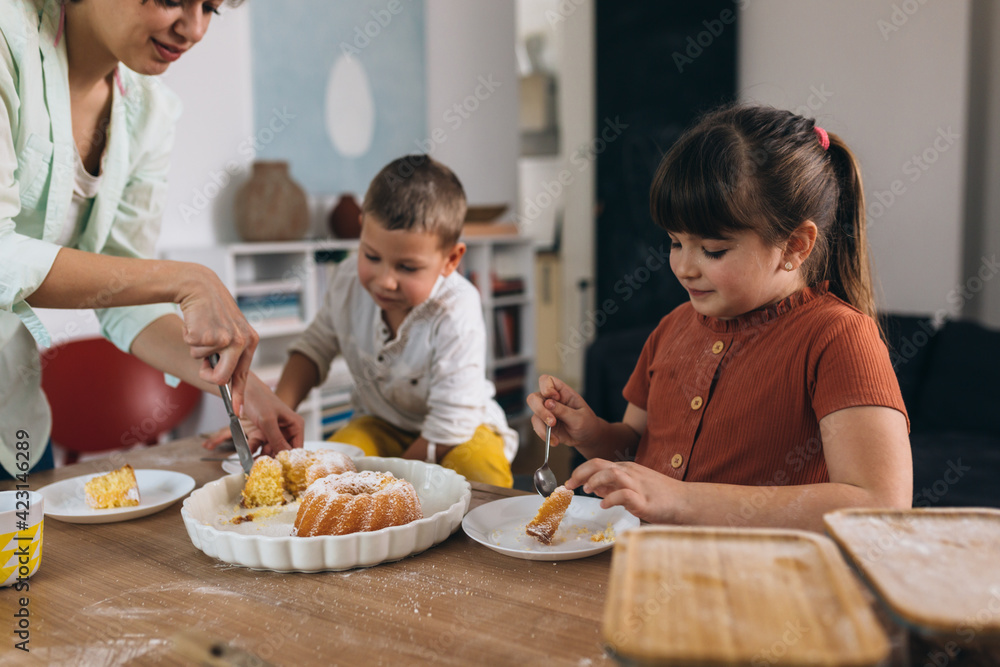 children eating cakes at home.