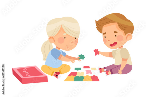 Happy Little Boy and Girl Playing Jigsaw Puzzle on the Floor Vector Illustration