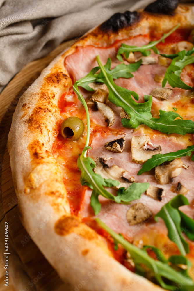Close up pizza with arugula, mushrooms, prosciutto and olives. Close up pizza with arugula, mushrooms, prosciutto and olives.