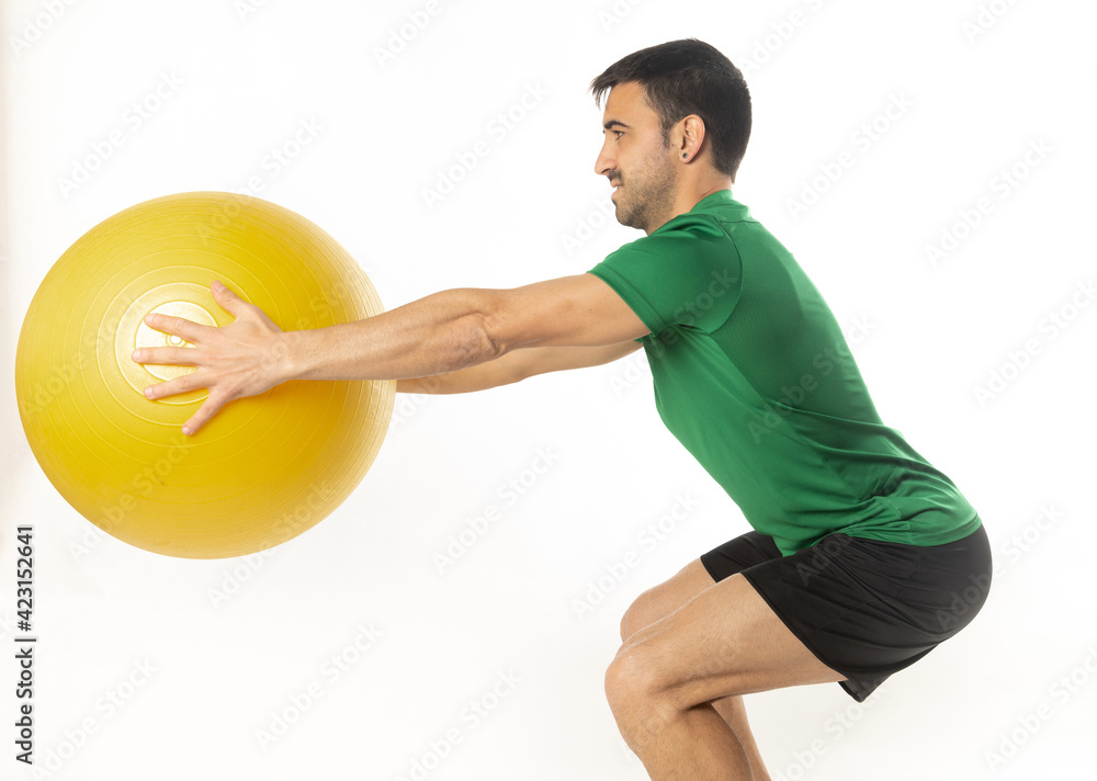 man exercising with fitball on white background