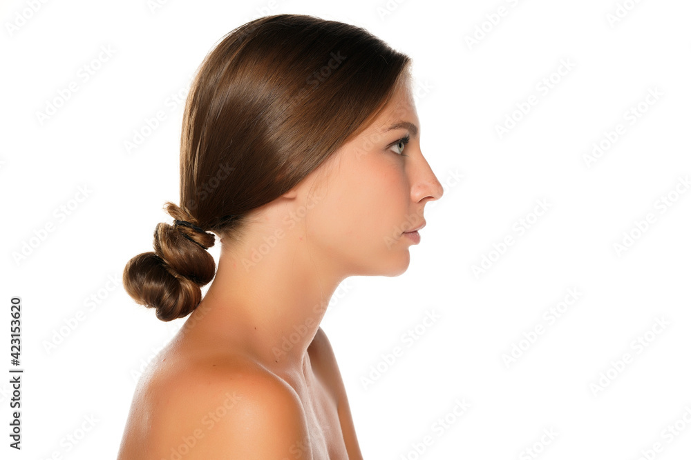 Profile of a young serious shirtless beautiful woman