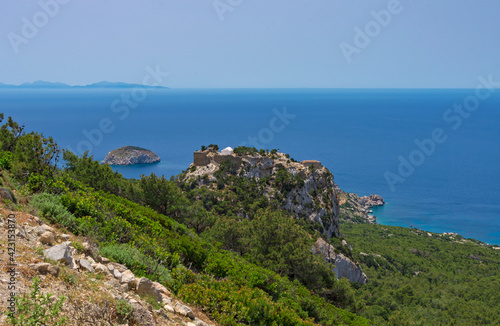 Beautiful seascape with of the medieval fortress Monolithos on the mountain top (Rhodes, Greece)