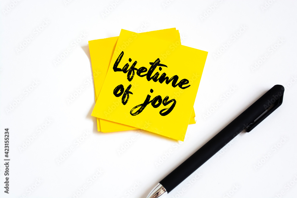 Text lifetime of joy on the short note texture background Text lifetime of joy on the short note texture background