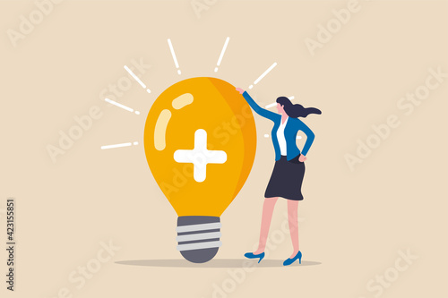 Positive thinking, optimistic bring success to work and living, inspiration and happiness in work concept, cheerful businesswoman standing with bright lightbulb idea with positive sign.