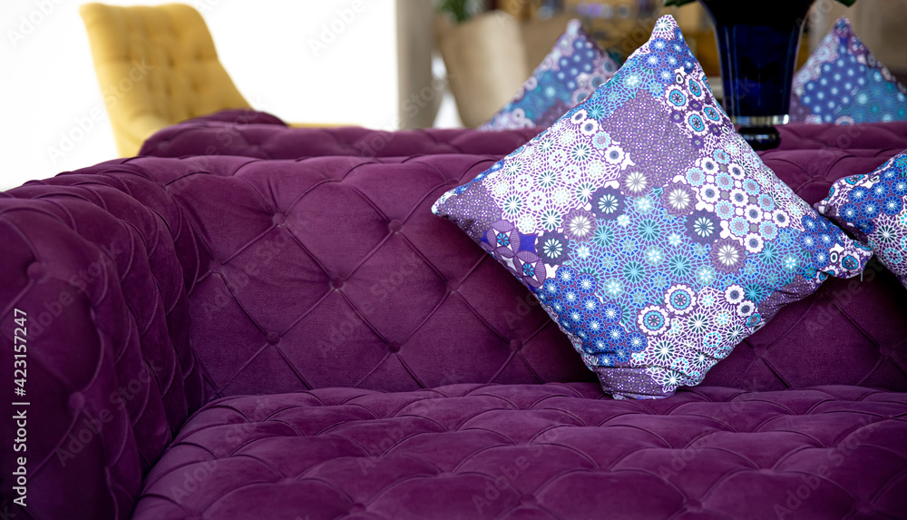 Purple velvet fabric modern sofa with sunken buttons and colorful decorative pillows. Purple velvet fabric modern sofa with sunken buttons and colorful decorative pillows.