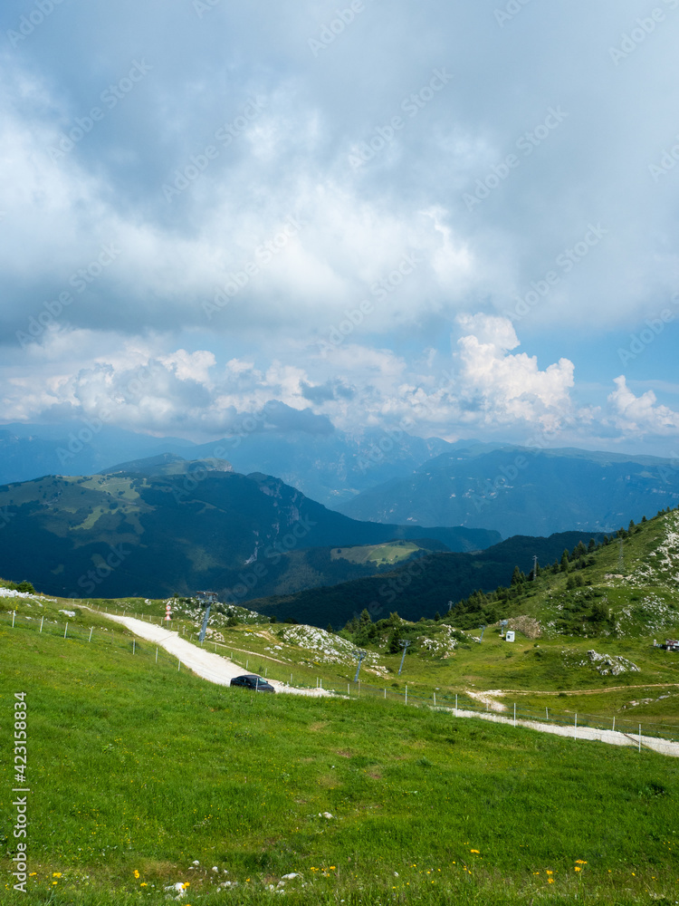 The view valley the mountains of Monte Baldo in Malcesine in Italy in a green meadow.