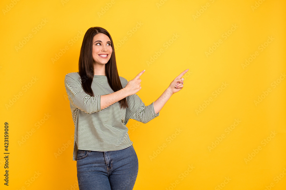 Portrait of attractive cheerful girl demonstrating copy empty space ad way isolated over bright yellow color background Portrait of attractive cheerful girl demonstrating copy empty space ad way isolated over bright yellow color background
