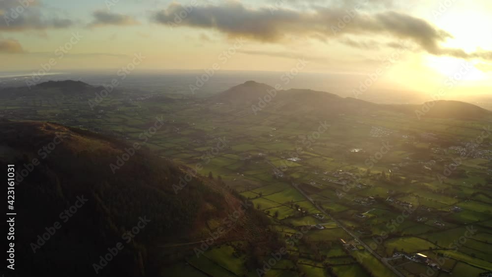 Wintery sunset at Ring of Gullion, Newry, Northern Ireland. December 2019. Drone slowly tracks away from Slieve Gullion facing South towards Forkill. Wintery sunset at Ring of Gullion, Newry, Northern Ireland. December 2019. Drone slowly tracks away from Slieve Gullion facing South towards Forkill.