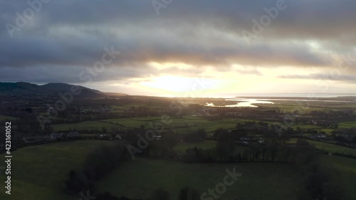 Wintery evening at Hill of Faughart, Louth, Ireland. 12 December 2019. Drone tracks slowly over rural farmland, while facing East towards Castletown River and Dundalk Bay. photo