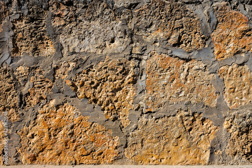 Close-up Decorative wall made of natural stone of various shapes and sizes. Interior background