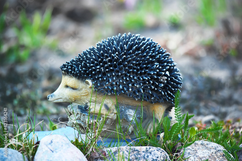 garden sculpture hedgehog among the grass © Evdoha