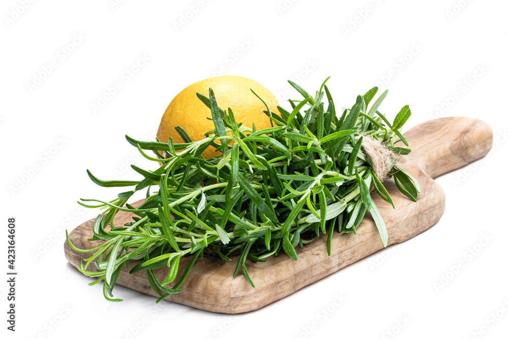 Bunch of fresh rosemary with fresh lemon isolated on white Bunch of fresh rosemary with fresh lemon isolated on white