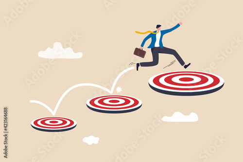 Aspiration and motivation to achieve bigger business target, advancement in career or business growth concept, smart businessman jumping on bigger and higher archery bull's eye target.