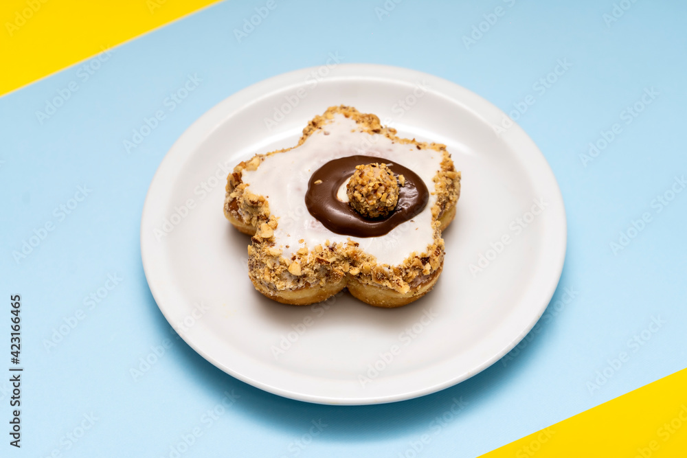 Donut on blue and yellow background Donut on blue and yellow background