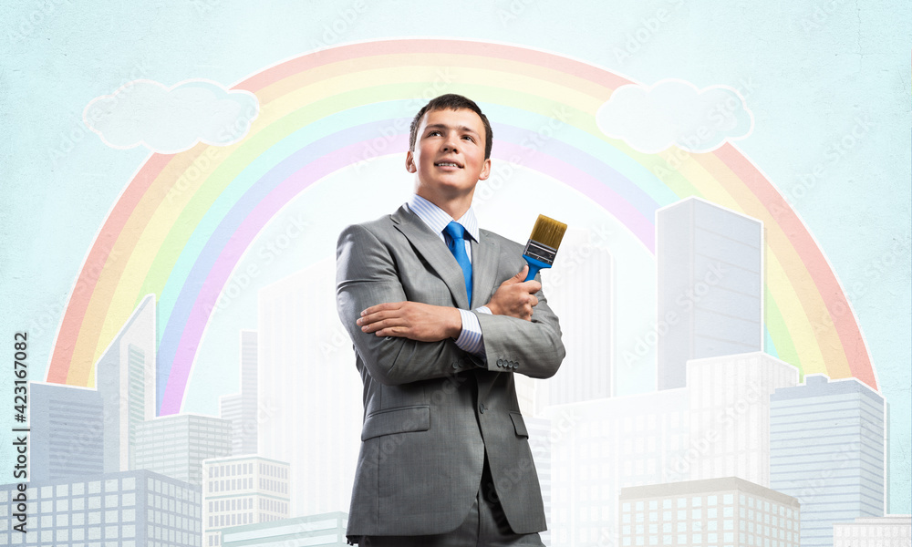 Creative businessman painter holding paintbrush Creative businessman painter holding paintbrush