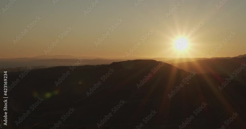 Glowing Sun Over Hilly Landscape Glowing Sun Over Hilly Landscape