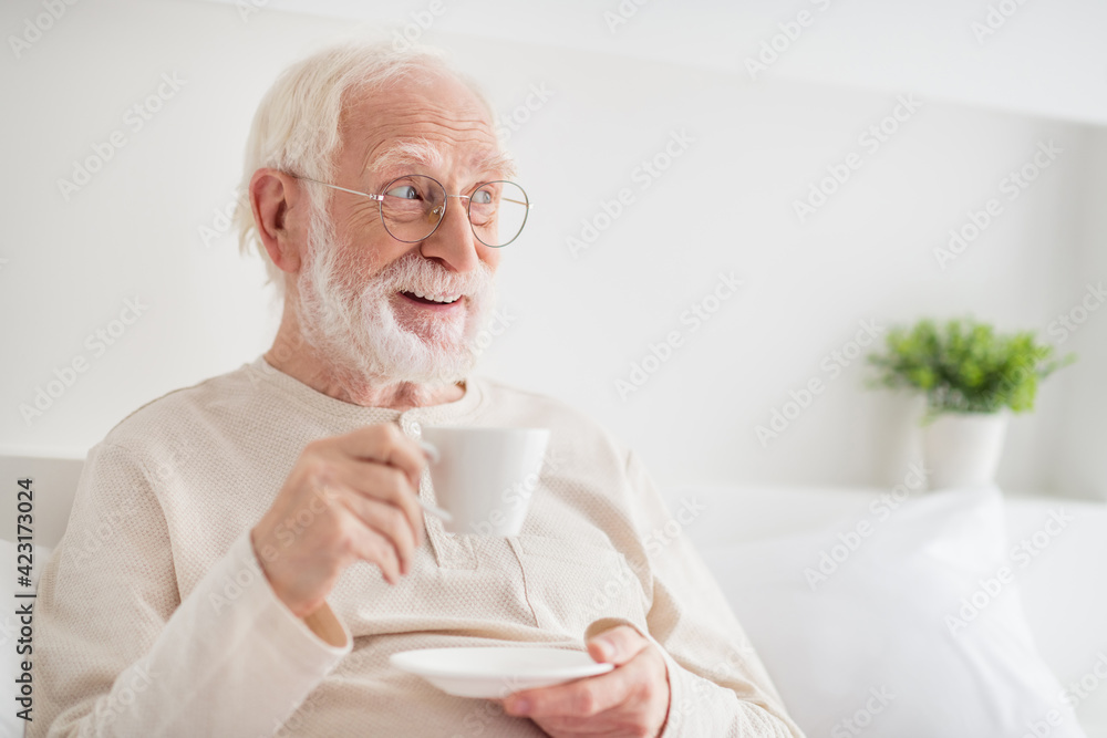 Photo of aged man happy positive smile enjoy morning cup of hot tea dream dreamy look empty space home Photo of aged man happy positive smile enjoy morning cup of hot tea dream dreamy look empty space home