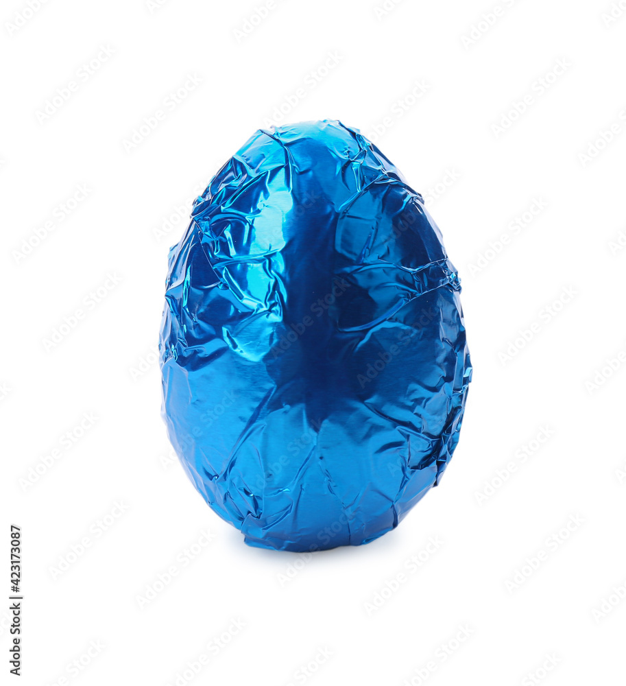 Chocolate egg wrapped in blue foil isolated on white Chocolate egg wrapped in blue foil isolated on white