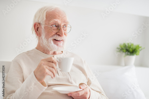 Photo of aged man happy positive smile enjoy morning cup of hot tea dream dreamy look empty space home