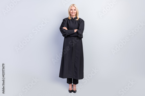 Full length photo of cheerful happy mature lady wear professional judge uniform crossed hands isoalted on grey color background