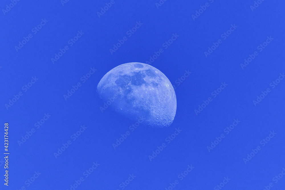 half moon during day light blue sky half moon during day light blue sky
