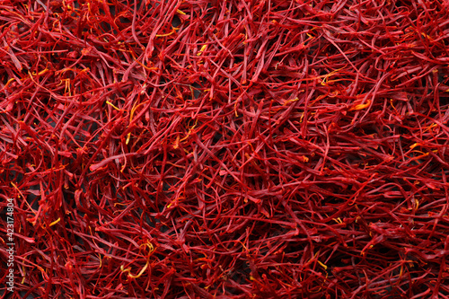 Red dried saffron as background, top view
