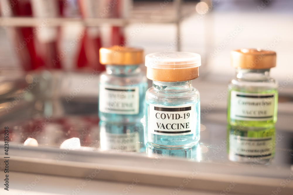 Close up a vial of covid-19 vaccine. Healthcare And Medical concept. Close up a vial of covid-19 vaccine. Healthcare And Medical concept.