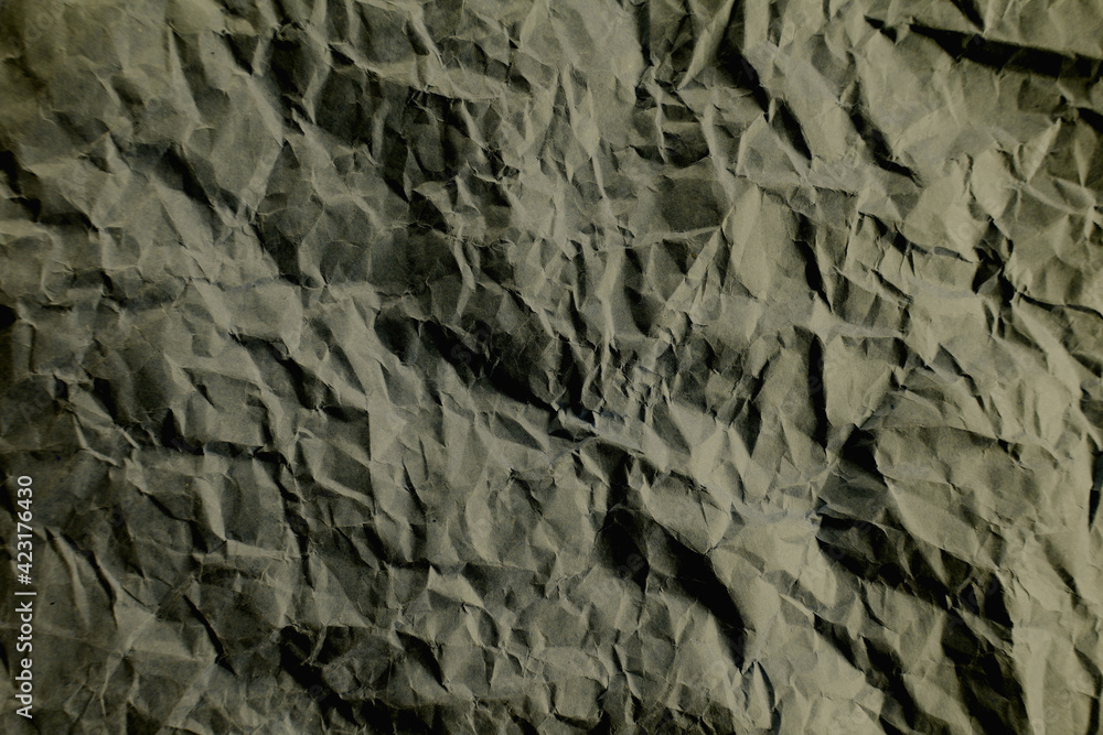 Top view photo of Crumpled craft paper. Grey color Paper background with copyspace. Vintage paper canvas texture abstract background. Top view photo of Crumpled craft paper. Grey color Paper background with copyspace. Vintage paper canvas texture abstract background.