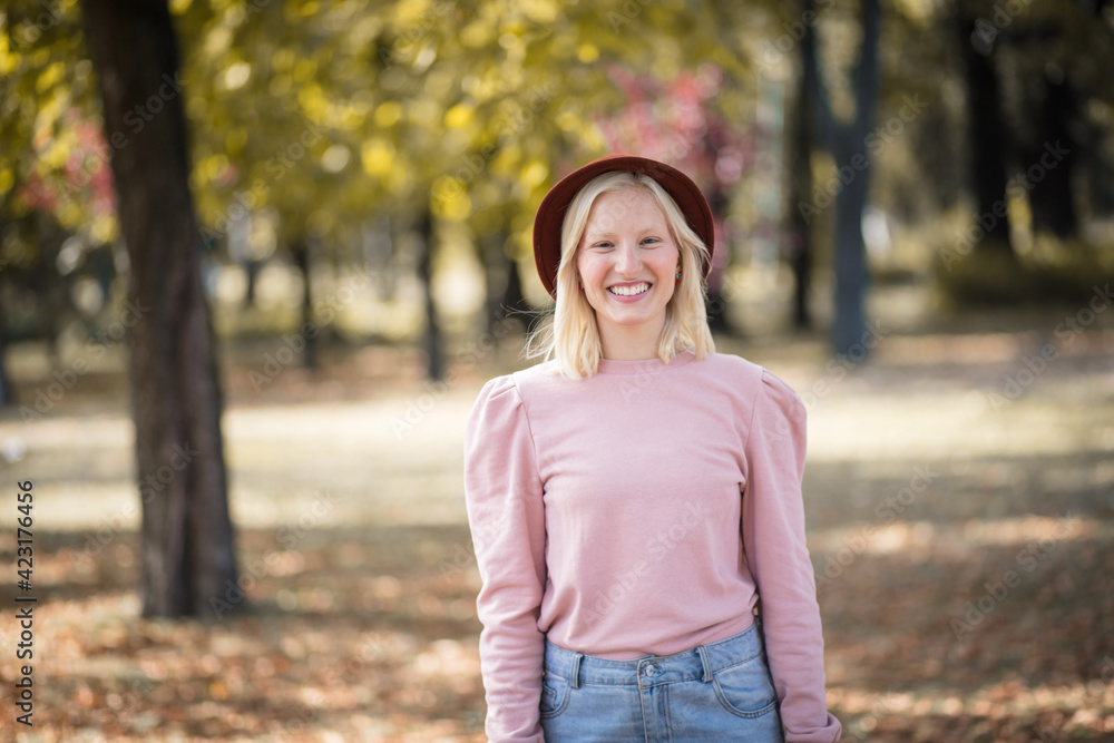 Young smiling blond woman enjoying in the park. Young smiling blond woman enjoying in the park.
