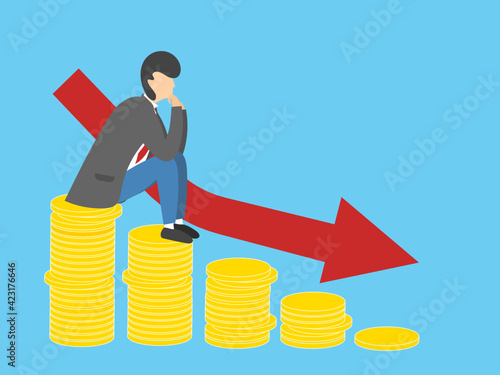 The stacks of coins in the declining chart show losses and stagnation. A sad man sits in thought. Business financial problems.