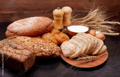 Bakery products. Various bread rolls. Healthy bread assortment. Collection of grain bread and baked goods on wooden background. Shopping food supermarket concept. Bread made from wheat and rye flour.