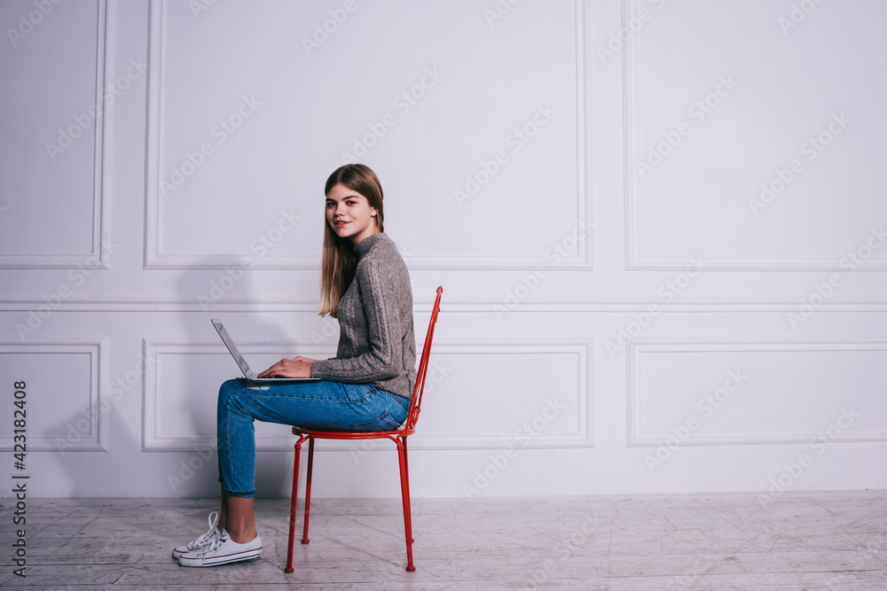 Young female freelancer with laptop on lap Young female freelancer with laptop on lap
