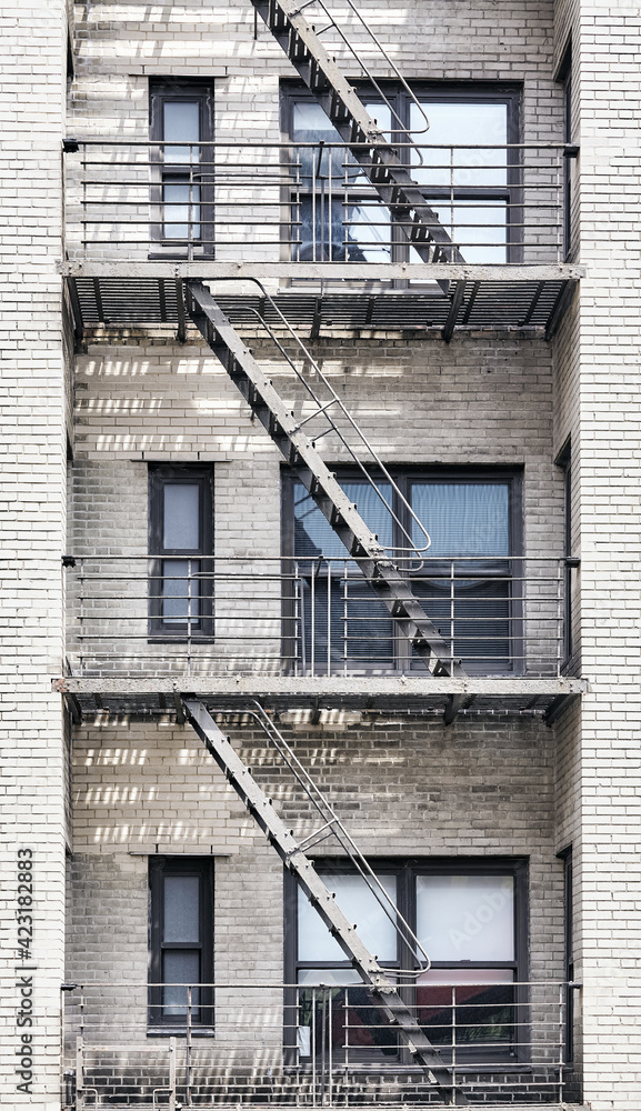 Old brick building with iron fire escape, New York City, USA.