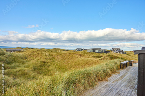 beach house of large green filed and blue sky