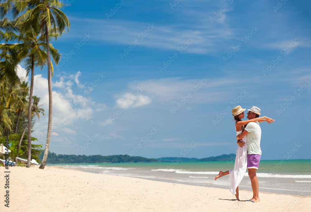 beautiful young couple on the beach. honeymoon concept beautiful young couple on the beach. honeymoon concept